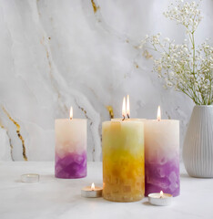 candle, gypsophila flower on a concrete background