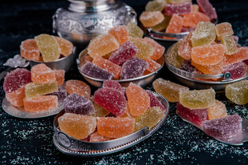 Dessert marmalade in the form of lemon and orange slices. The sweetness of jelly candy.