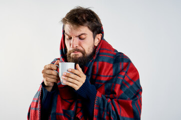 cold man with blanket warming drink health problem