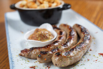 Grilled sausages with mustard and bread toast