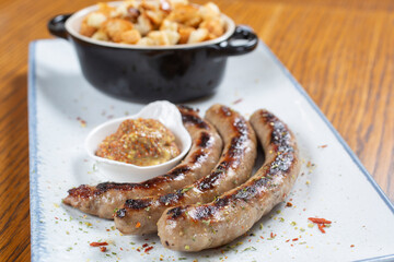 Grilled sausages with mustard and bread toast