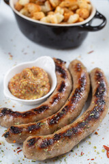 Grilled sausages with mustard and bread toast