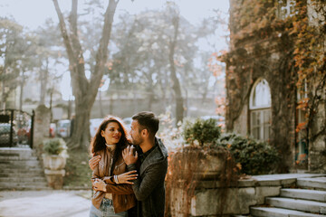 Young couple standing by the stairs of the old house