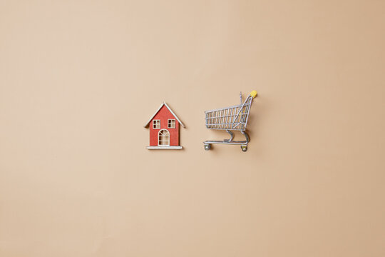 Little Toy House And Shopping Cart On Stark White Background.