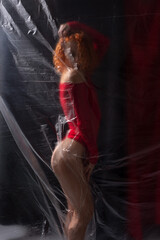 sexy girl athlete in a red bodysuit on a dark background