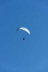 Paragliding Pilot Flying a Paraglider - 468448174