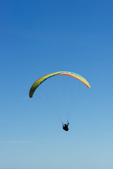 Paragliding Pilot Flying a Paraglider - 468448185