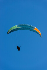 Paragliding Pilot Flying a Paraglider - 468448196