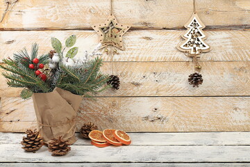 Empty rustic table with live Christmas tree in eco bag and wooden decorations.Christmas and New...