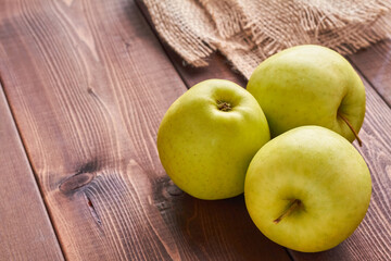 golden delicious apple on brown background