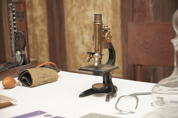 The old microscope was used at the doctor's workplace many years ago