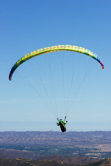 Paragliding Pilot Flying a Paraglider - 468452518