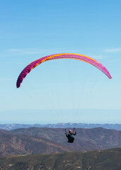Paragliding Pilot Flying a Paraglider - 468452570