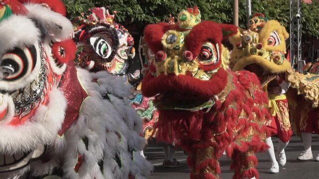 Chinese lion performing at night, Lunar new year celebration in Chinatown, Slow motion. 