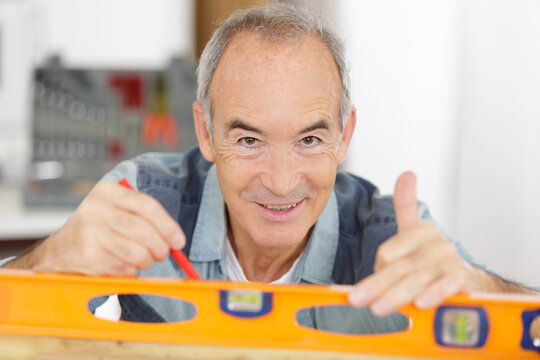 a senior man doing diy