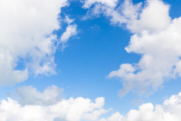 Naklejka na ściany i meble White cumulus clouds in blue sky on a daytime