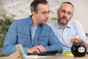 gay couple doing financial counting together
