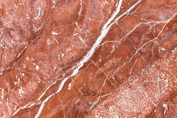 Red marble pattern with white veins. Close-up photo texture