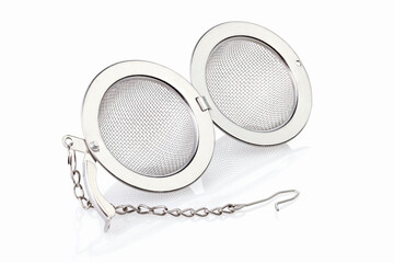 Tea strainer on a chain isolated for white background. A tea strainer is a kitchen accessory...