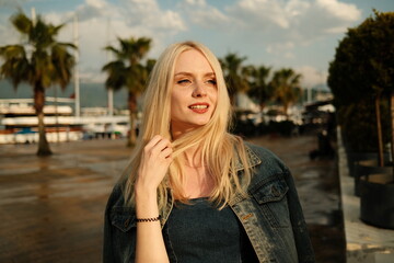 Portrait of Beautiful young blonde girl at sunset in Batumi