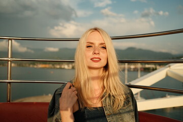 Portrait of Beautiful young blonde girl at sunset in Batumi