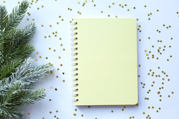 Yellow blank notepad on christmas background with sparkles