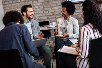 Group of diverse group of business people having a meeting while sitting in circle.