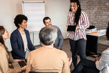 Group of diverse group of business people having a meeting while sitting in circle.