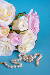 pearls and white roses on a blue backgroundv