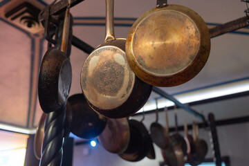 saucepans hanging from a rack in the kitchen.