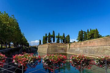 Walls of the fortress of Peschiera di Garda, surrounded by lake water.