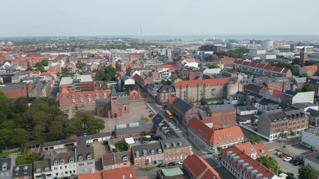 Aerial view through Esbjerg, Denmark with Vor Frelser kirke, the Church of Our Saviour. Drone view over the city street neighborhood revealing one of the most important harbor of the north sea