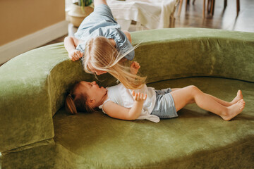 Naughty kids are messing around on the couch. Sters argue.