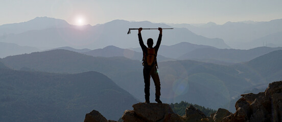 silhouette of a person in the mountains