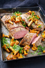 Fried dry aged pork fillet chateaubriand medallion steak natural with chanterelles and parsley...