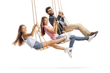 Happy family swinging on wooden swings - obrazy, fototapety, plakaty