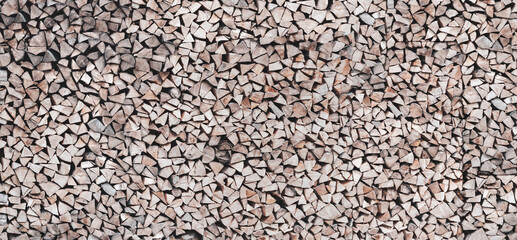Woodpile with firewood close up. Wooden texture.