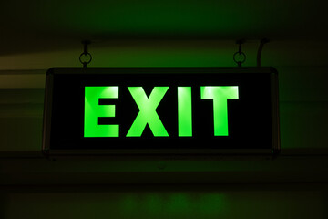 Neon sign with the inscription EXIT. Motion indicator in a dark room or space during evacuation