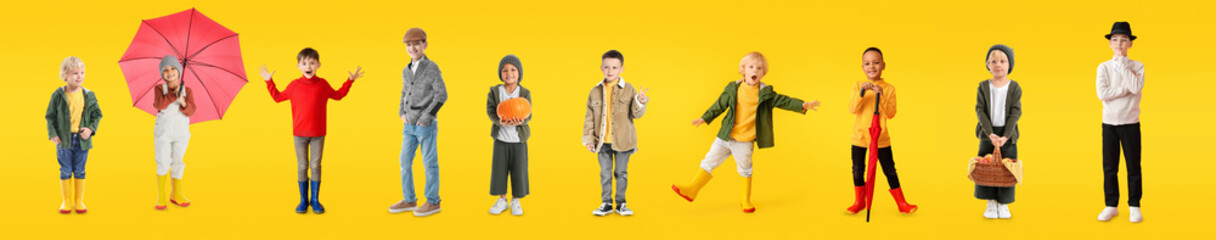 Group of stylish little boys in autumn clothes on yellow background