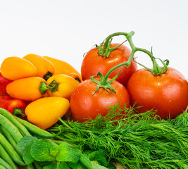 Fresh vegetables and greens on the board, food close up. Group of fresh vegetables on wooden table.