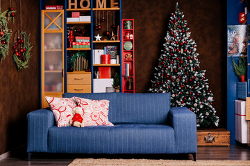 Decorated Christmas room with cozy sofa and beautiful Christmas tree