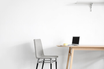 Stylish workplace near wall in room