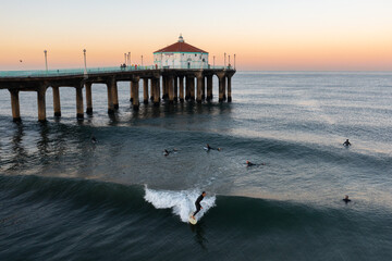 Surfers near the Manhattan Beach Pier in Southern California.