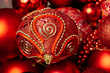 Christmas toys in red colors for decorating a festive Christmas tree. the idea for the interior of the living room in the house. jewelry close-up - obrazy, fototapety, plakaty
