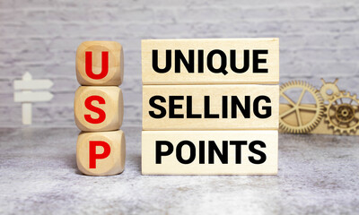 text UNIQUE SELLING POINTS - USP on wooden block