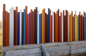 The background view of the fence, walls, strips of steel poles, in many different colors.