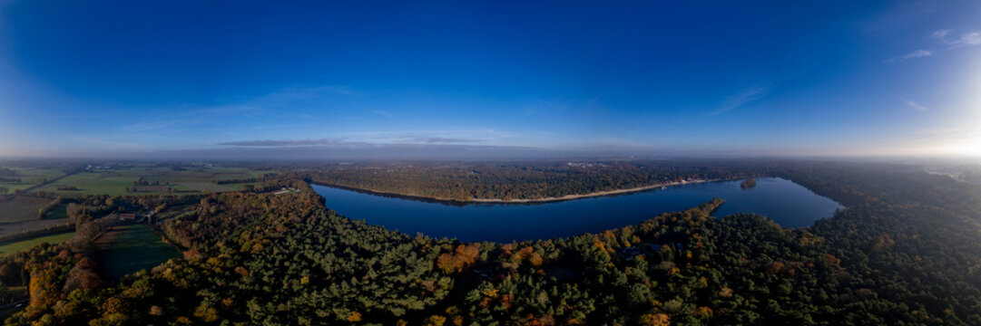 View from above horse head shaped De IJzeren Man lake surrounded by autumn forest with beaches on its shores. Aerial Dutch panorama landscape scenery. © Maarten Zeehandelaar