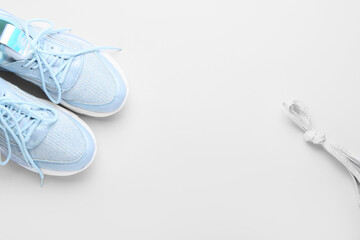 Sportive shoes and laces tied in knot on white background, closeup