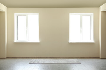 Light wall with windows and rug in big room
