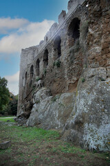 Ruined castle exterior wall with a decorative lion statue, Old Monterano, Lazio, Italy